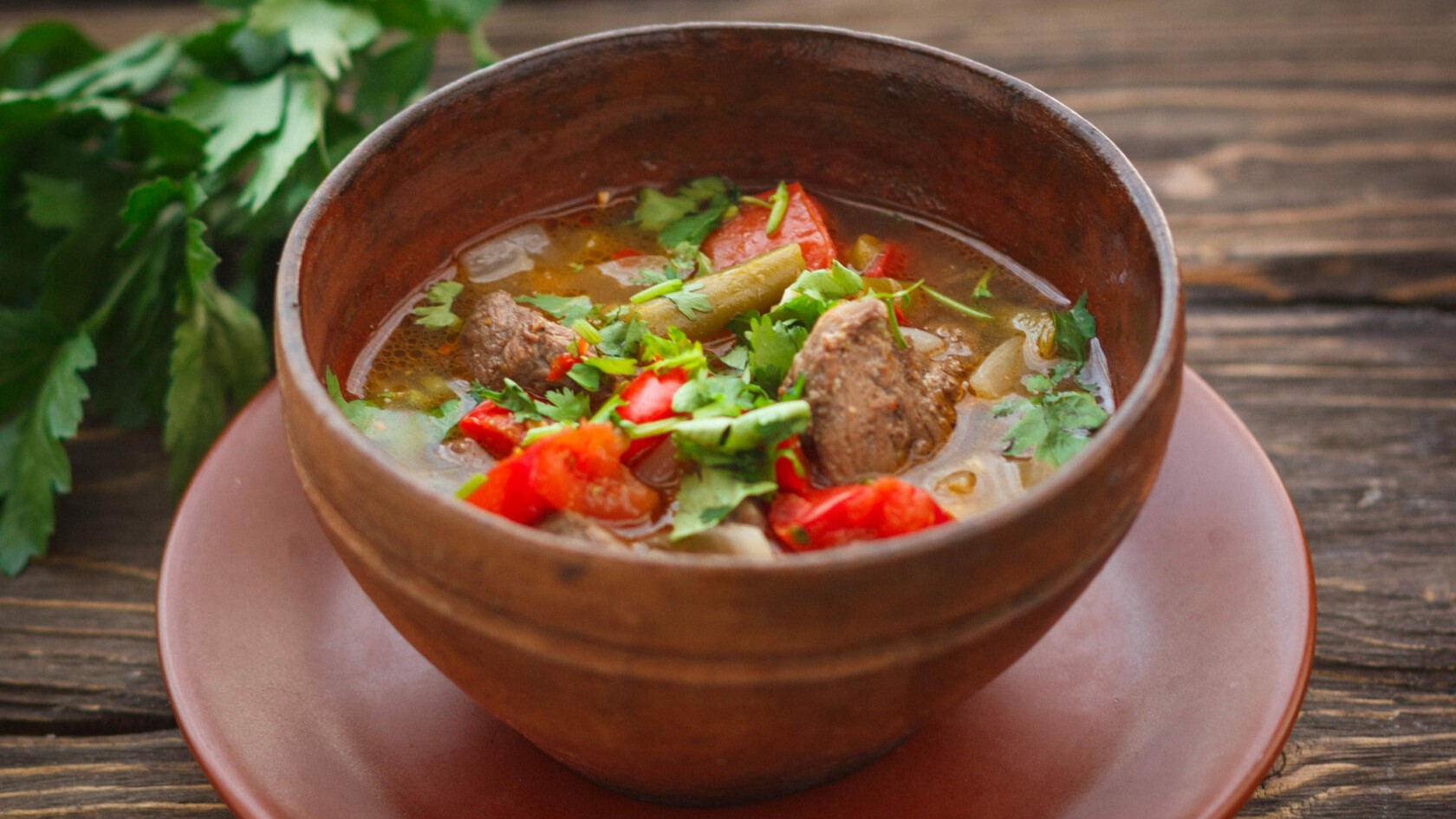 Bozbash traditional Azerbaijani lamb soup with vegetables served in communal bowl