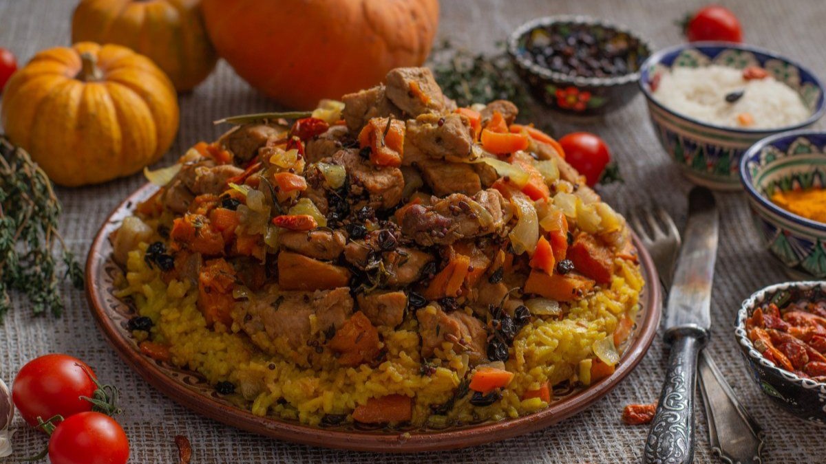 Traditional Azerbaijani plov rice dish with saffron, meat, and dried apricots